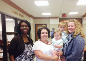 Leah Sharpshair holding Brayden, with HCJFS worker Brittany Rogers and HCJFS Adoption Worker Stacey Barton, holding Colton, who was adopted in January.